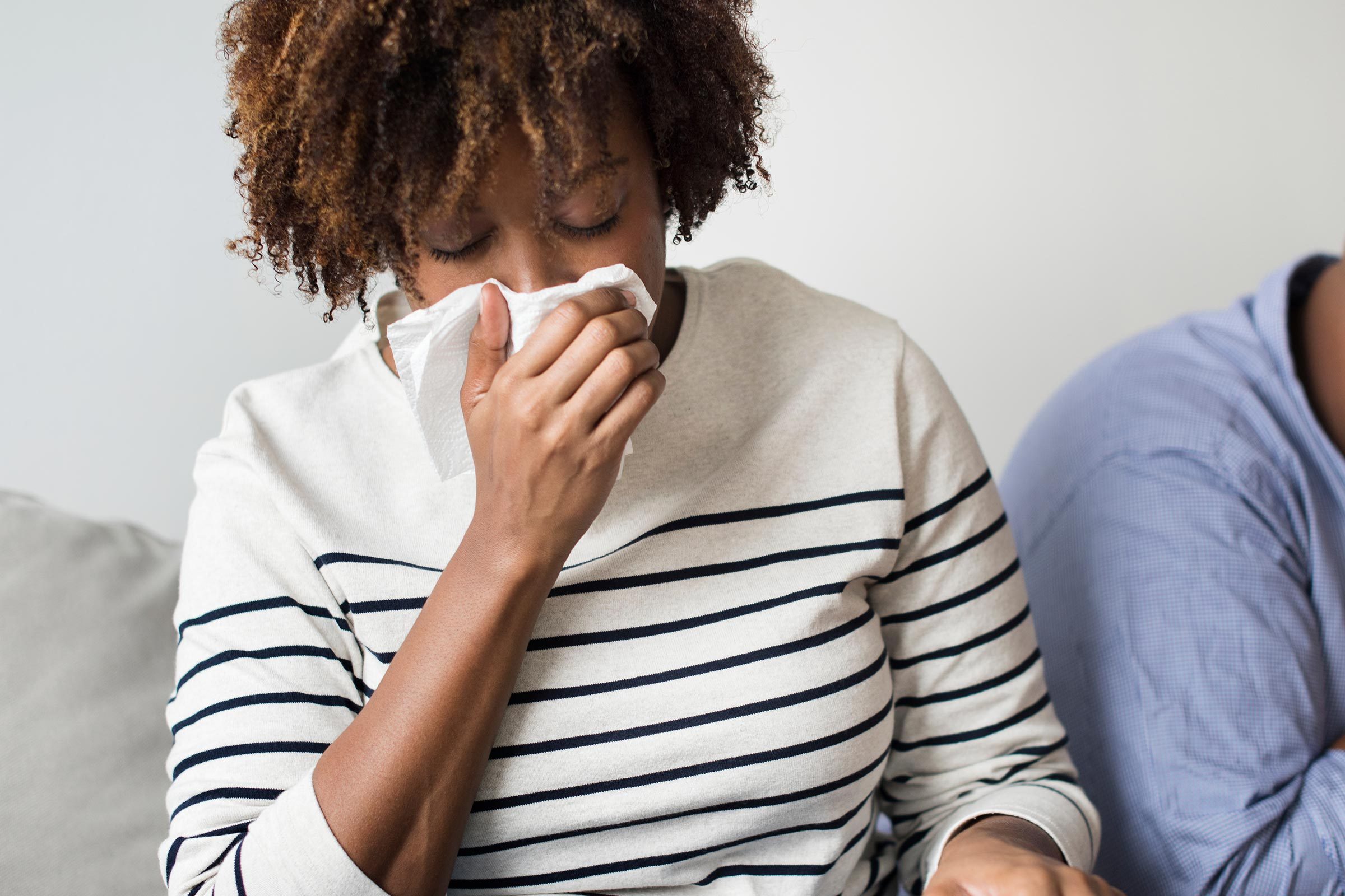 woman blowing her nose