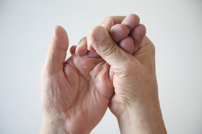 Man trying to restore feeling in his numb hands.