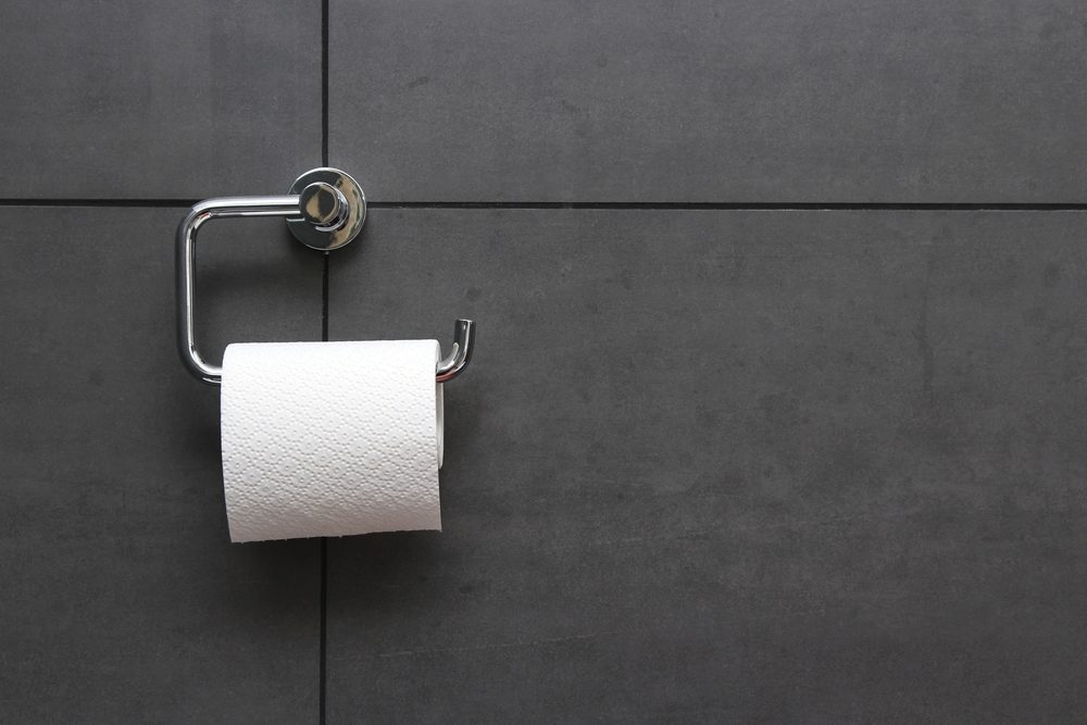 bathroom tissue on anthracite tiled wall