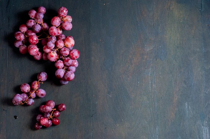 red grapes on old wood table background