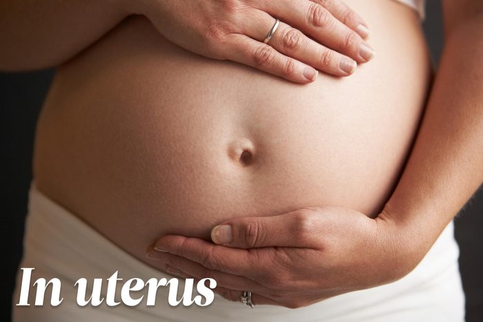 pregnant woman with hands on her belly