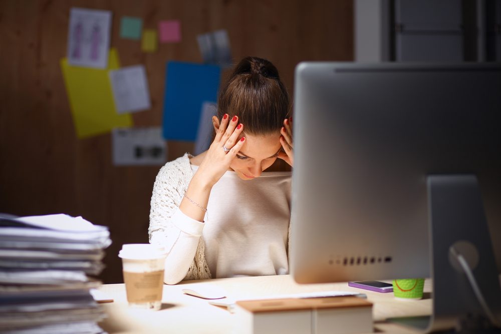 tired woman sitting at computer