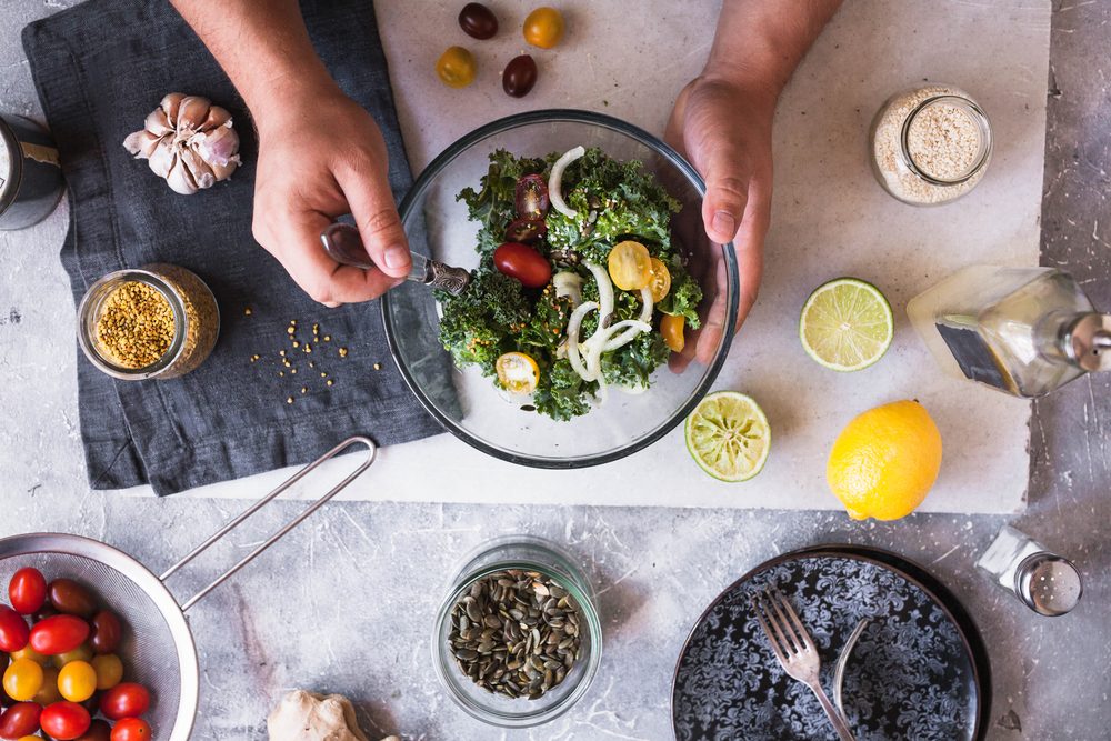 eating detox salad avocado kale brussels sprouts salad dinner food hands eating green salad