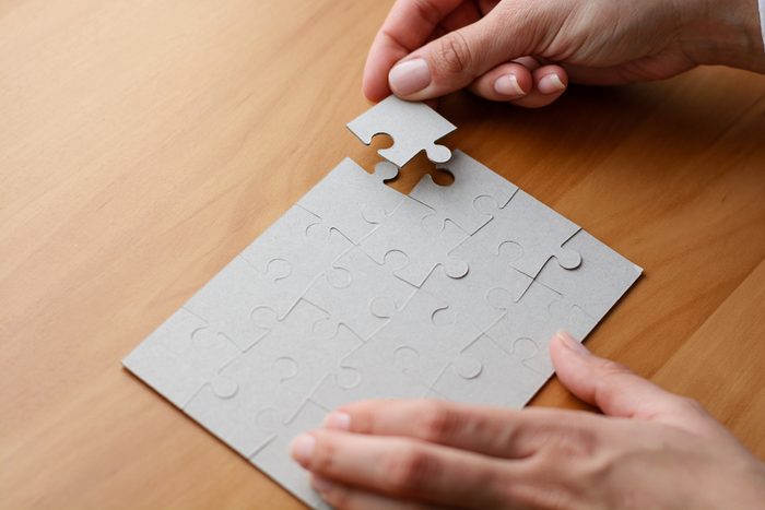 hands doing a puzzle