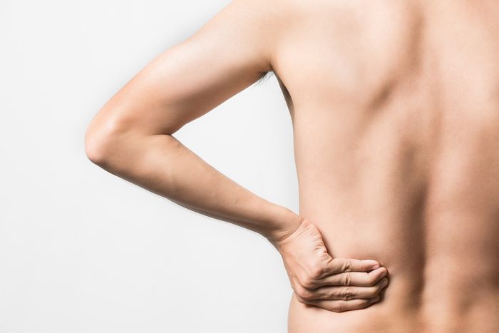 man with hand on his lower back