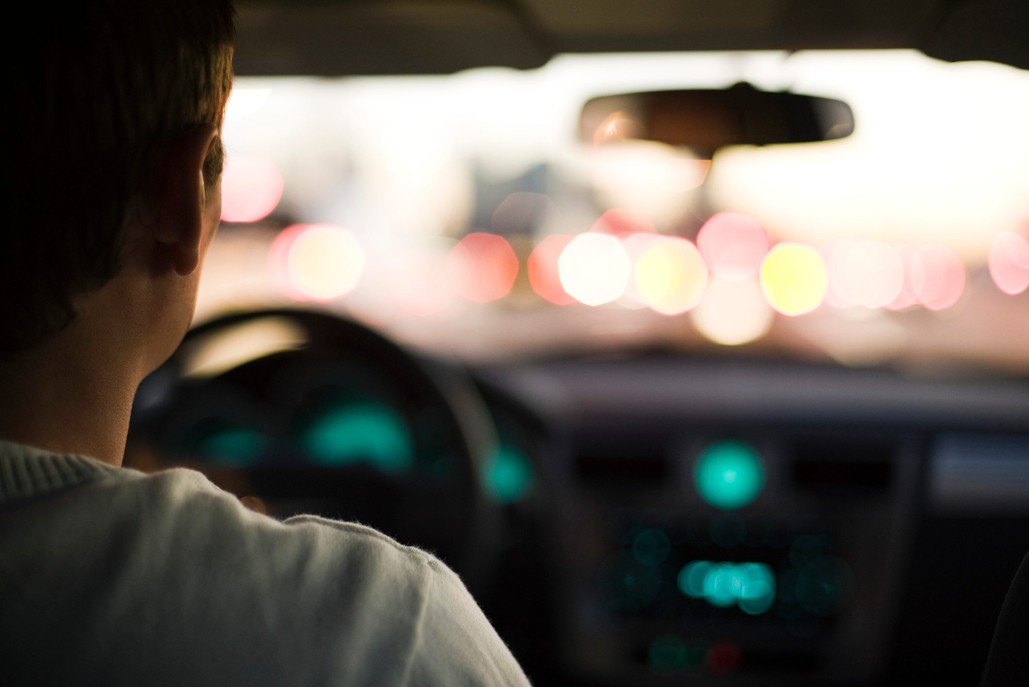 rear view of man driving in traffic