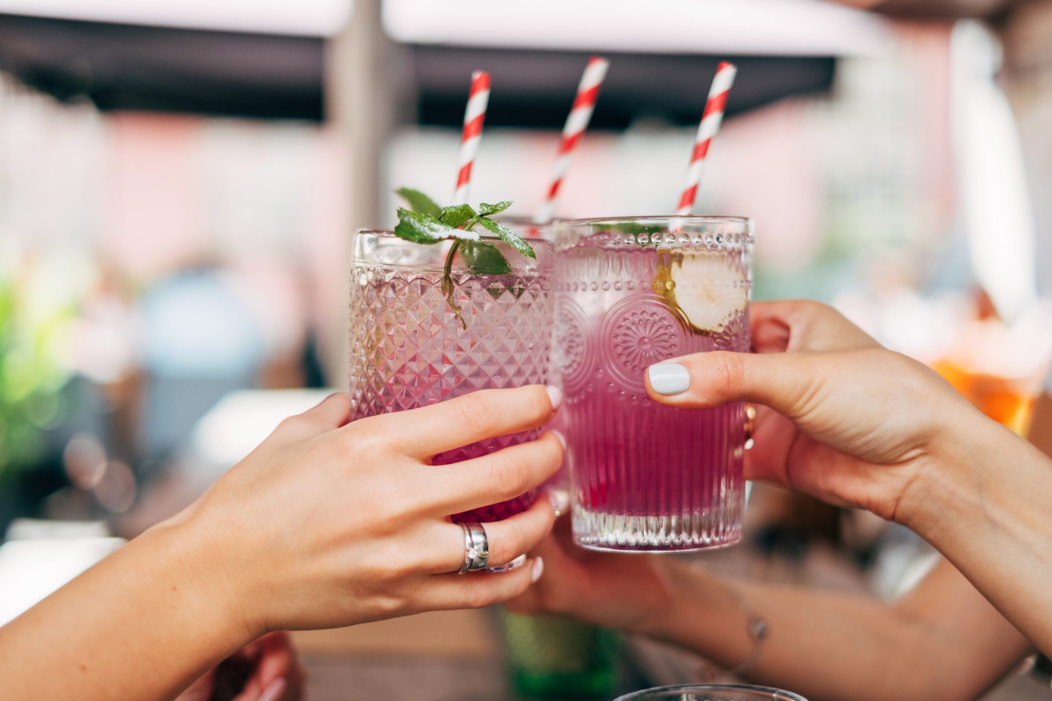 group of women holding cocktails