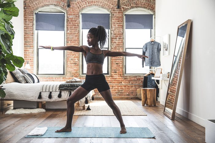 woman stretching at home