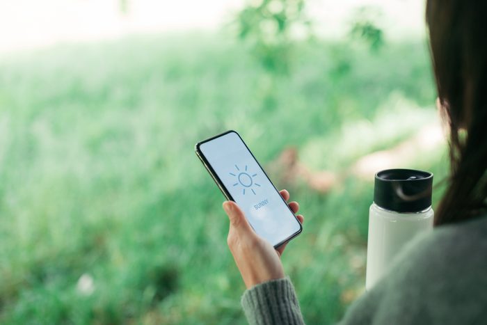 woman checking weather on phone