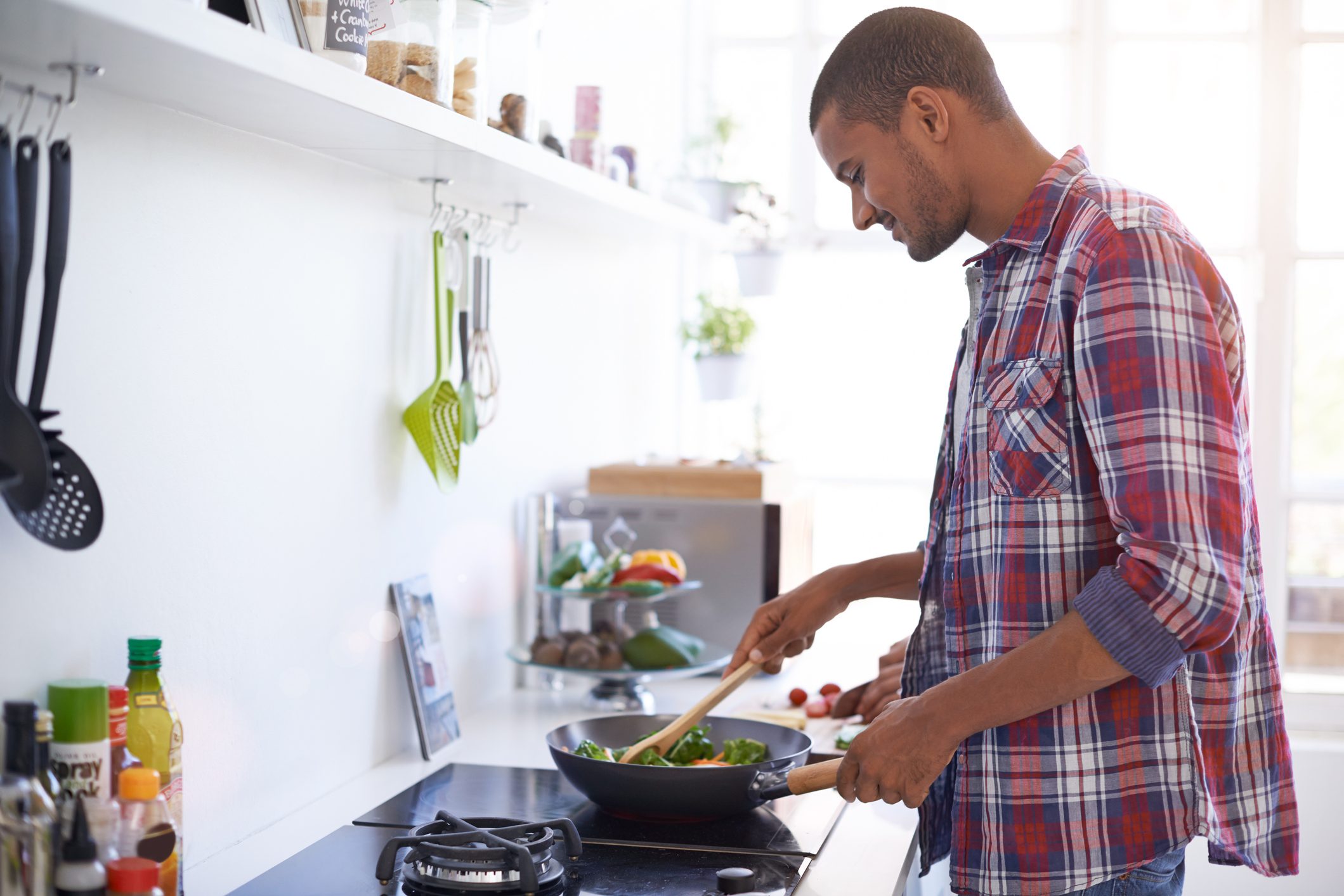 man cooking a meal in kitchen