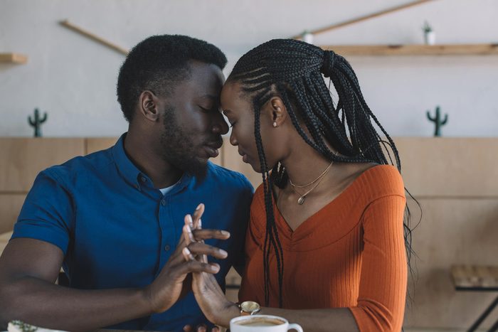man and woman holding hands, intimately