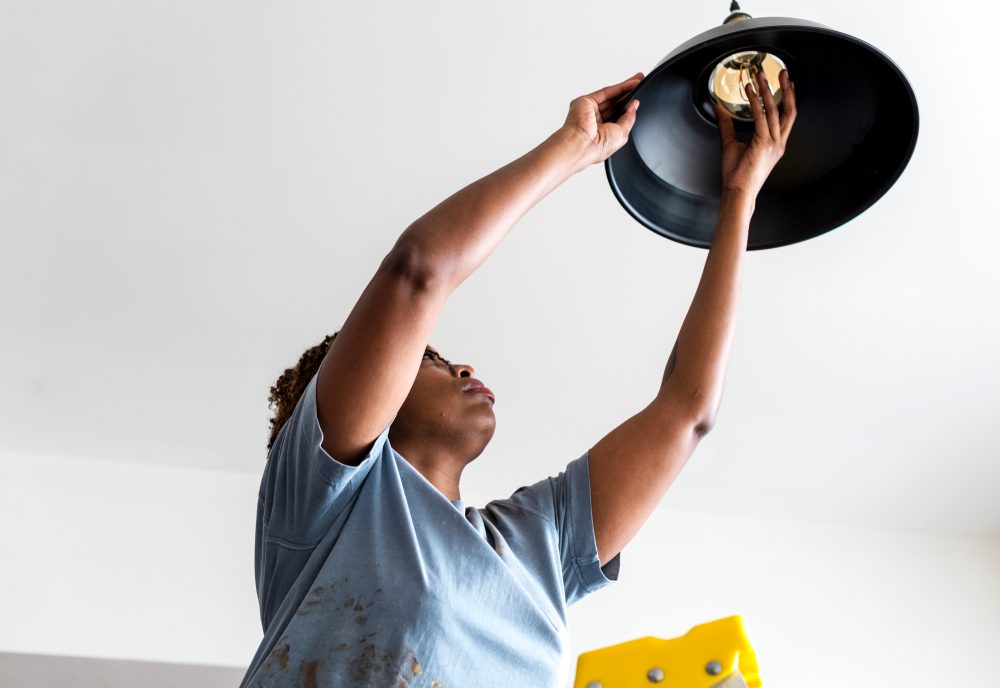 Woman changing lightbulb