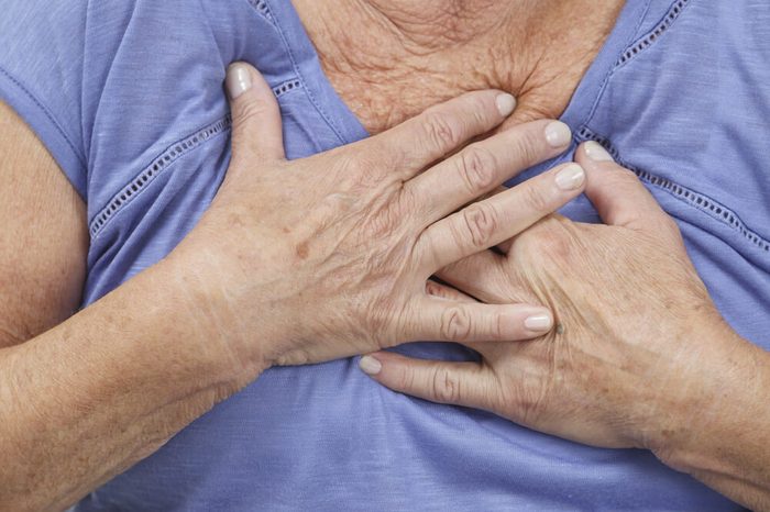 Woman with hands on chest