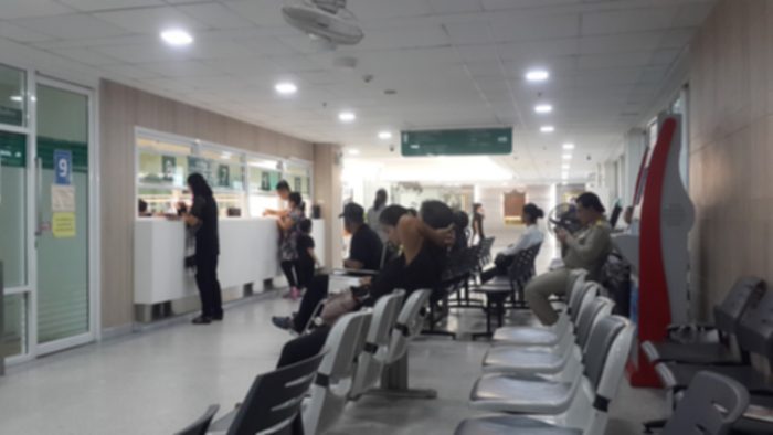 crowded pharmacy with long lines