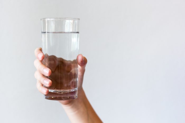 hand holding glass of water