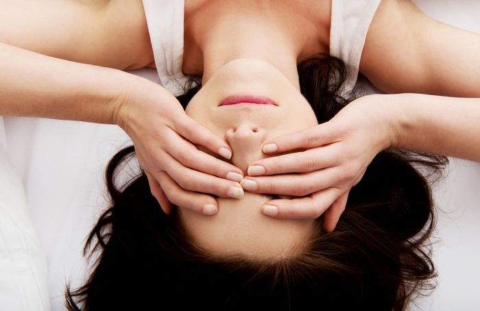 Sleepy woman waking up and rubbing her eyes.