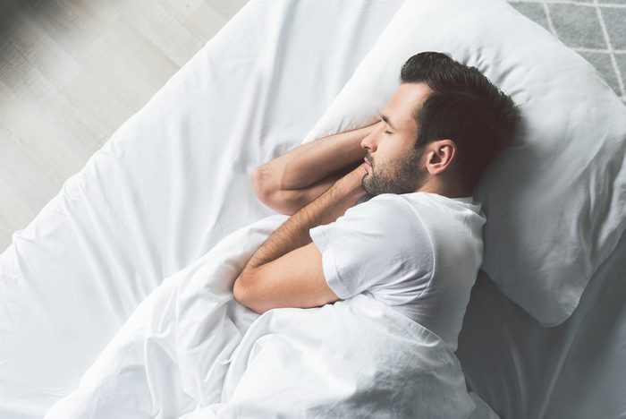 man sleeping in bed