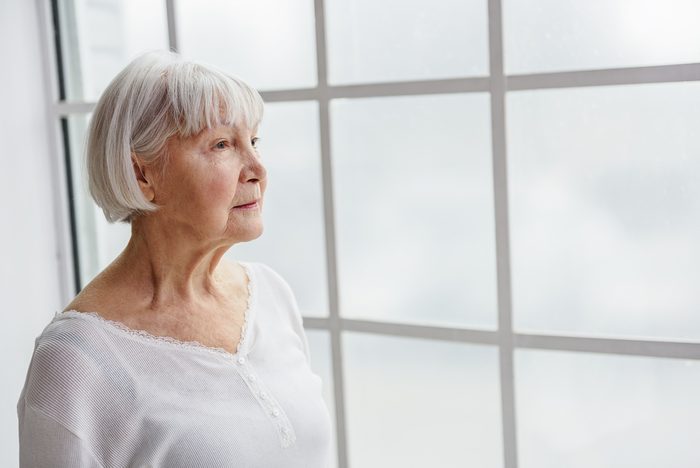 older woman looking out the window