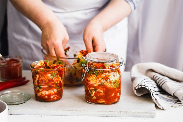 Base Cabbage Kimchi. Person preparing cabbage kimchi. Fermented and vegetarian preserved food concept.