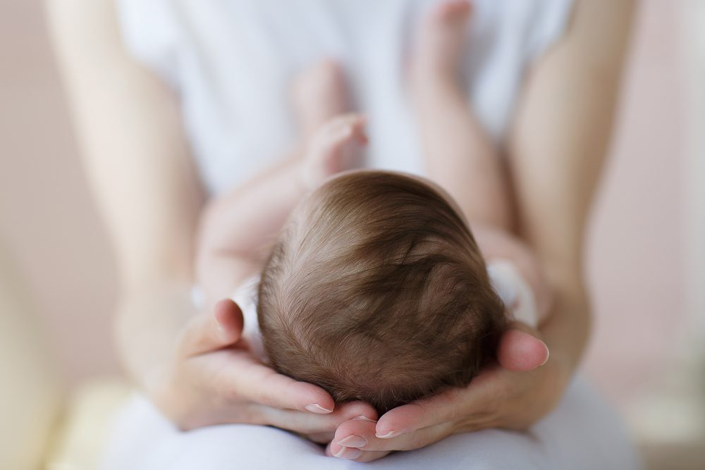 Mother holding newborn baby in her hands