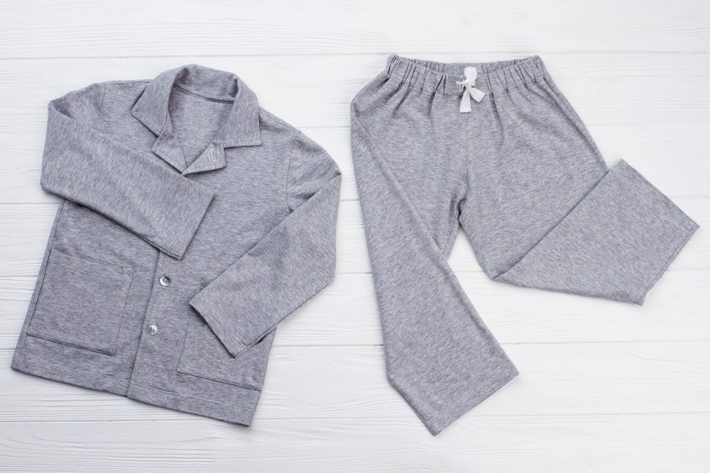 Boys' pajama set on white. Soft gray melange cotton. Loose-fitting shirt and pants for comfort rest at night.