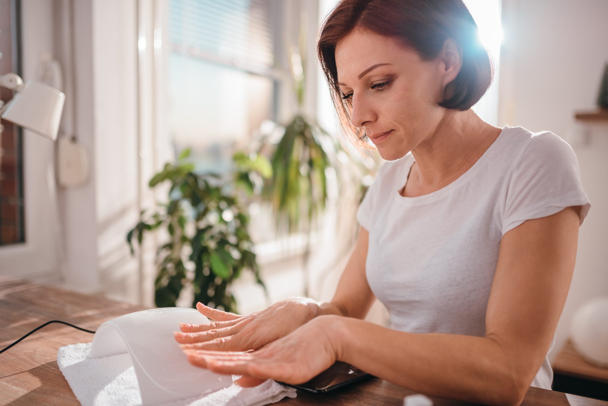 woman looking at her finger nails