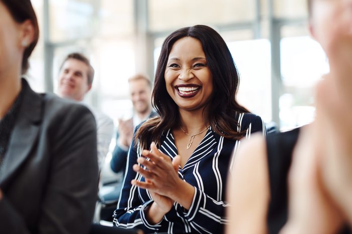 woman smiling and clapping