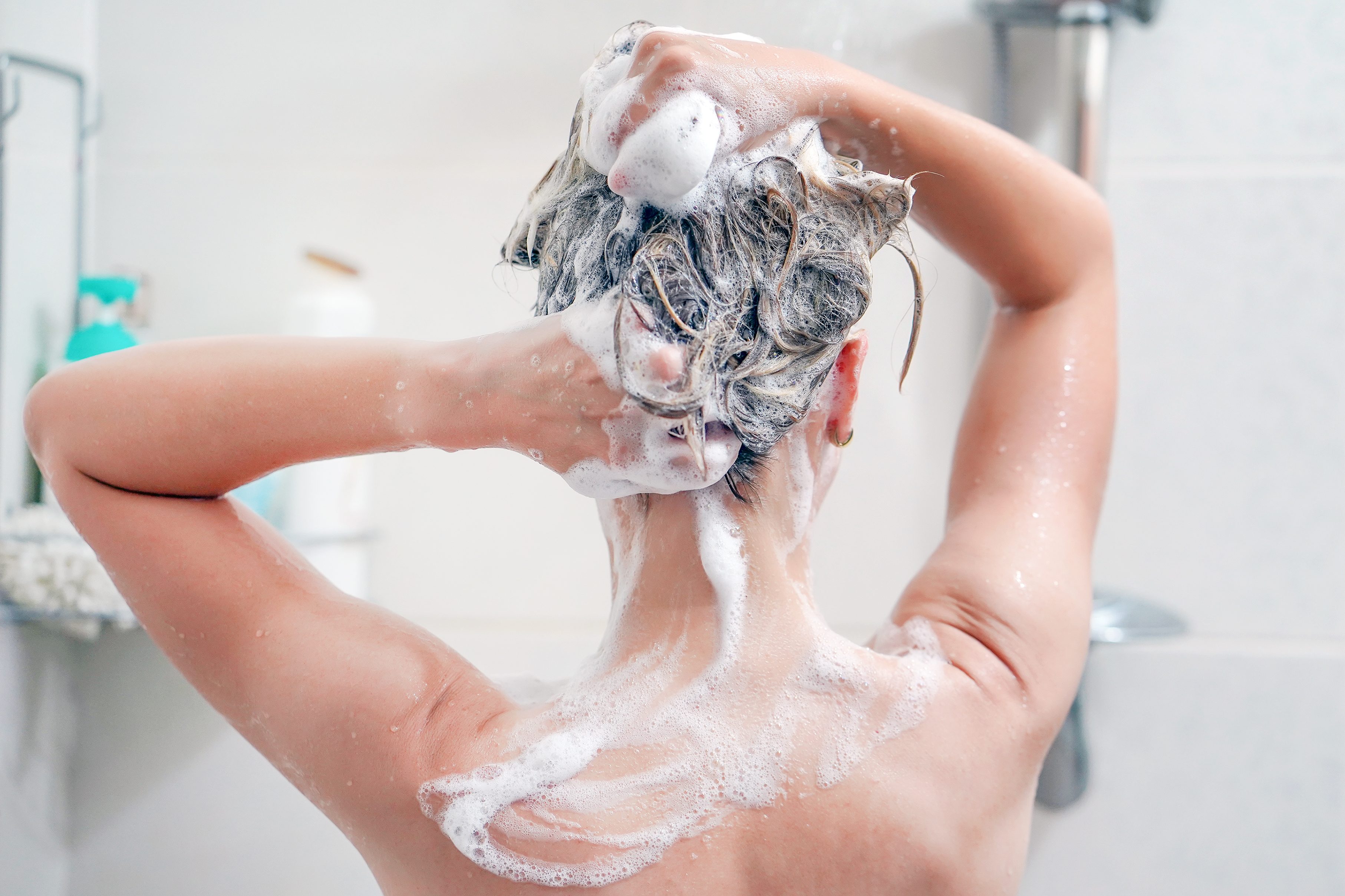 woman washing her hair in the shower