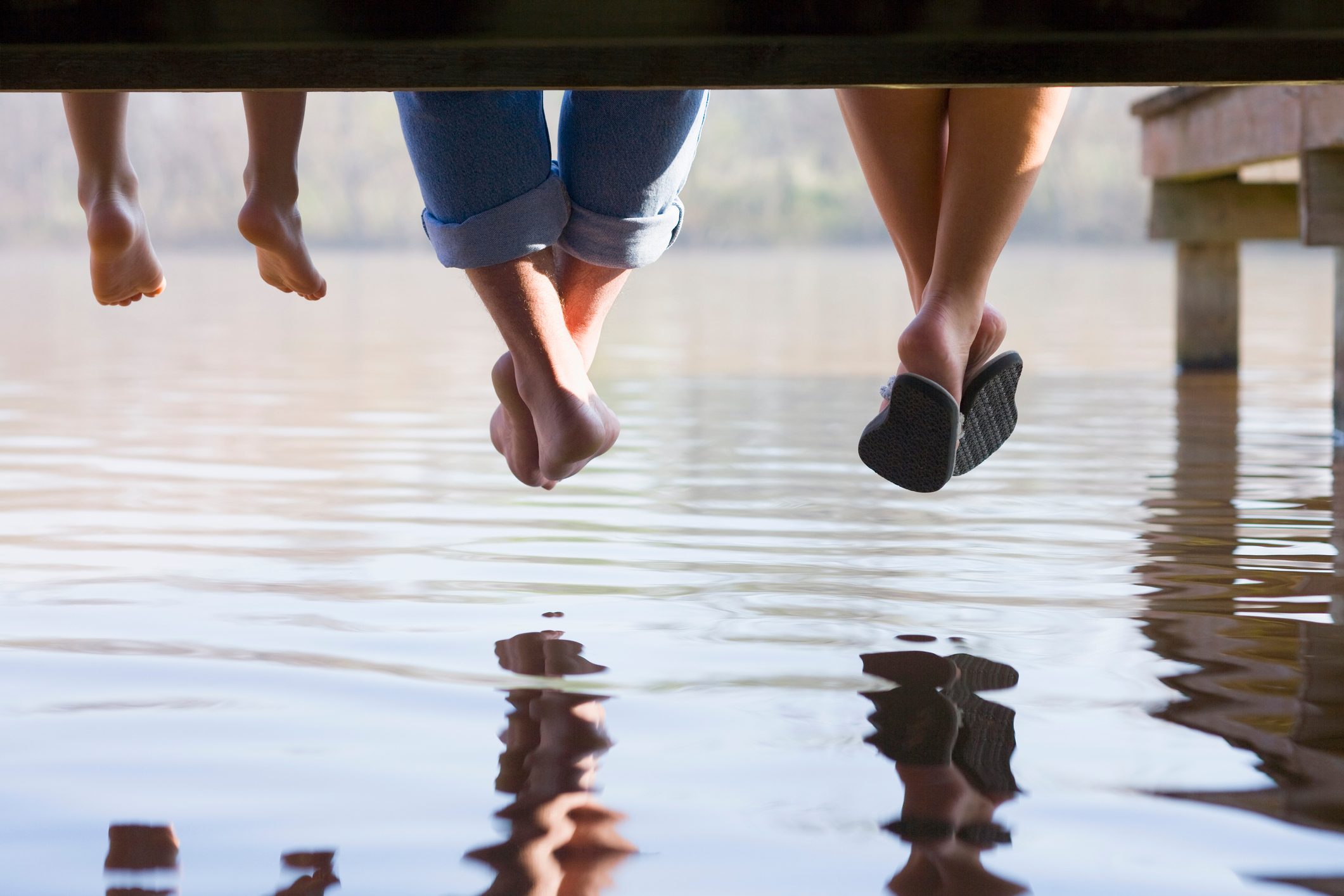 feet hanging off of dock