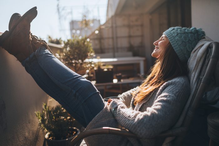 young woman sitting outside enjoying fresh air