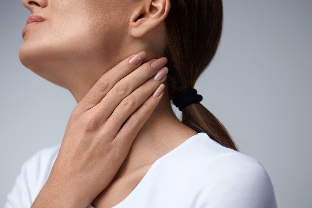 Throat Pain. Closeup Of Sick Woman With Sore Throat Feeling Bad, Suffering From Painful Swallowing. Beautiful Girl Touching Neck With Hand. Illness, Health Care And Medicine Concepts. High Resolution