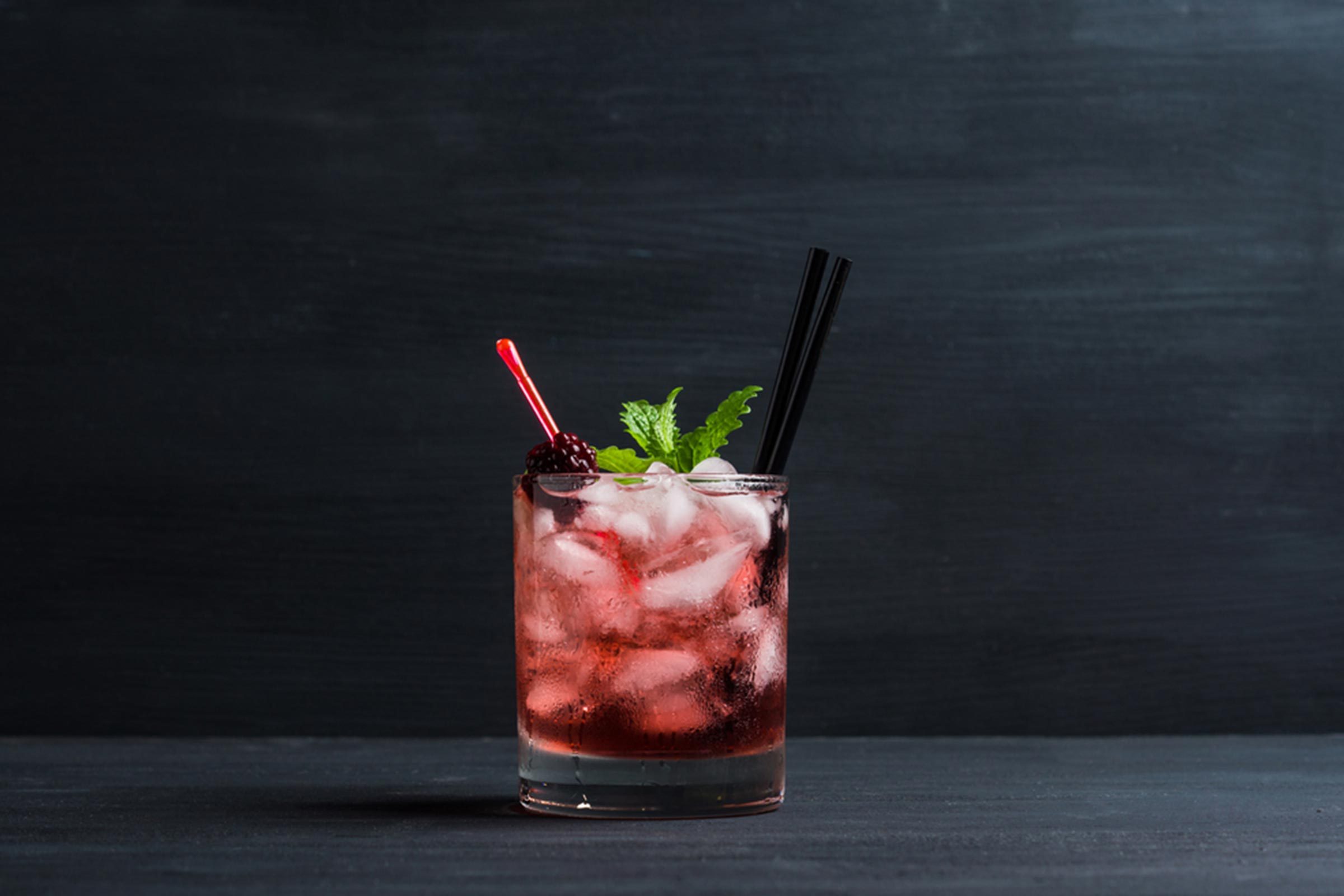 red cocktail with ice and mint