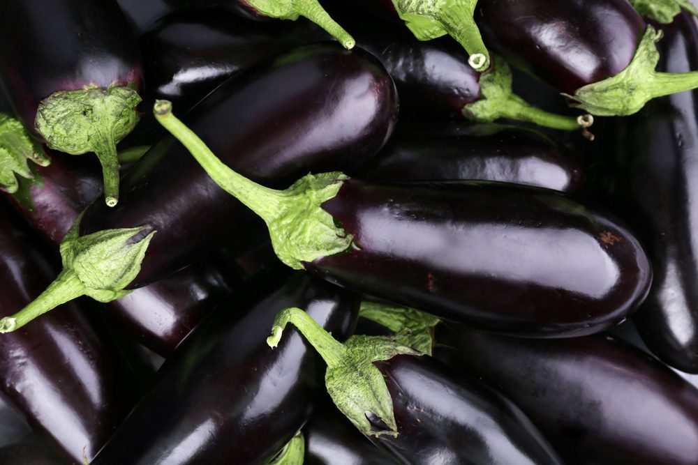 Heap of fresh eggplants close up