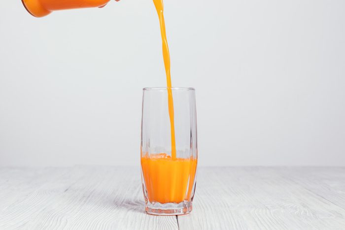 juice pouring from a pitcher into a glass