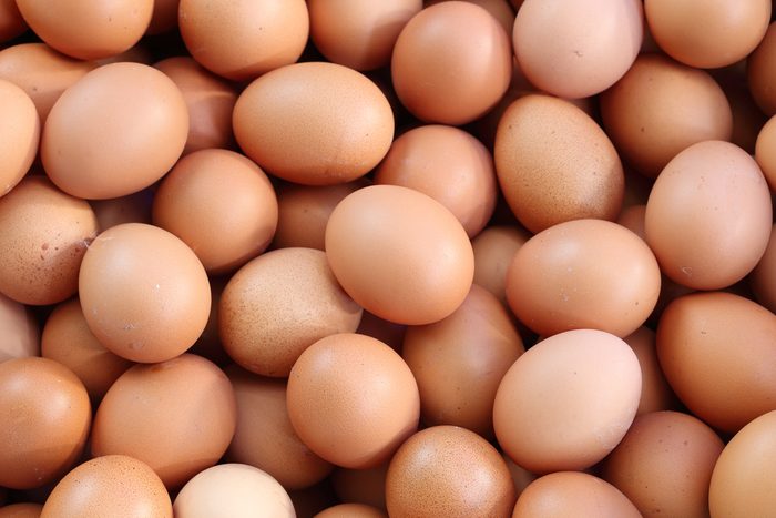 many fresh brown eggs for sale at a market