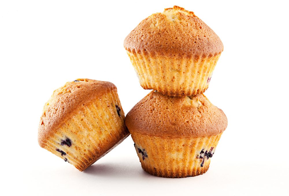 Tasty muffins with blueberry on white background