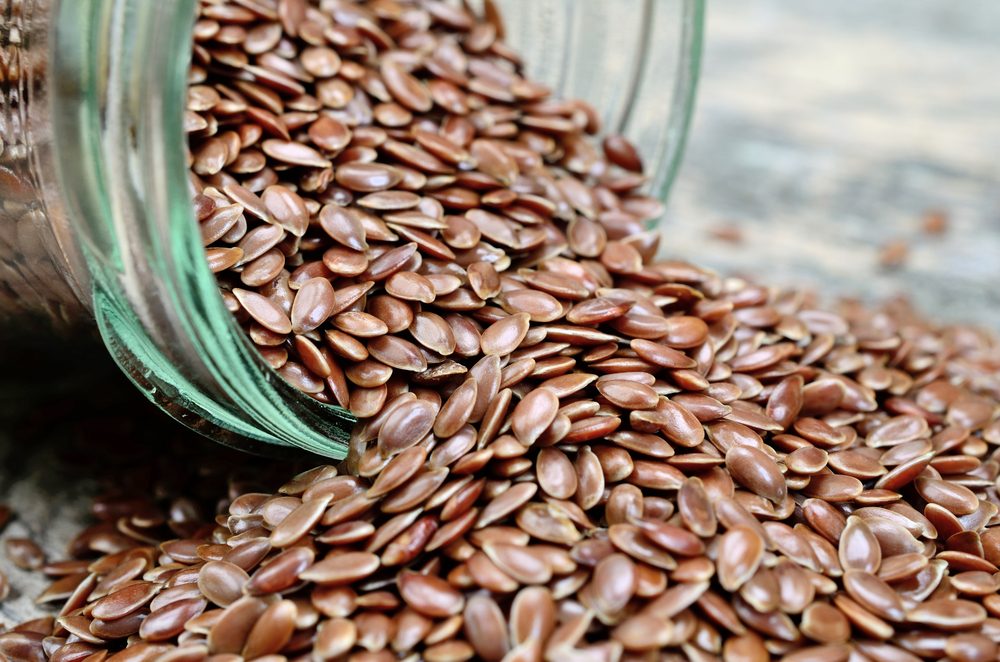 jar with flaxseed on wooden table