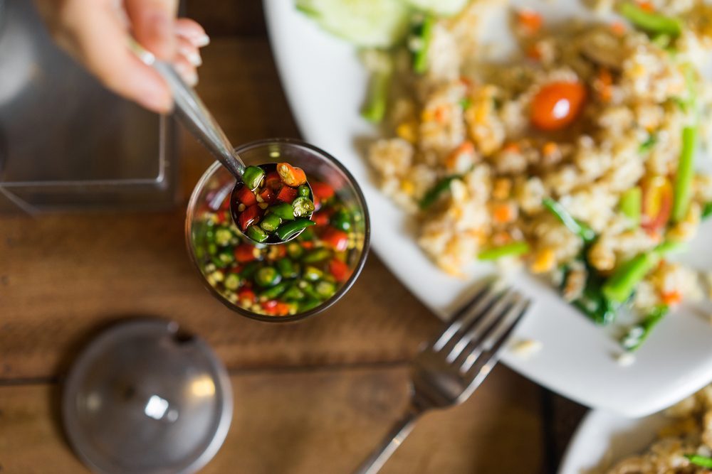 Spicy food. Red and green hot peppers in oil