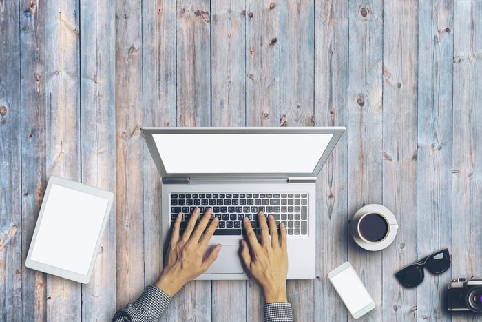 hands typing on laptop