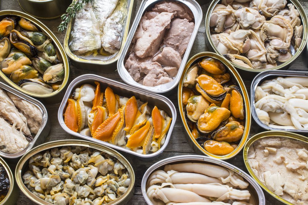 Assortment of cans of canned with different types of fish and seafood