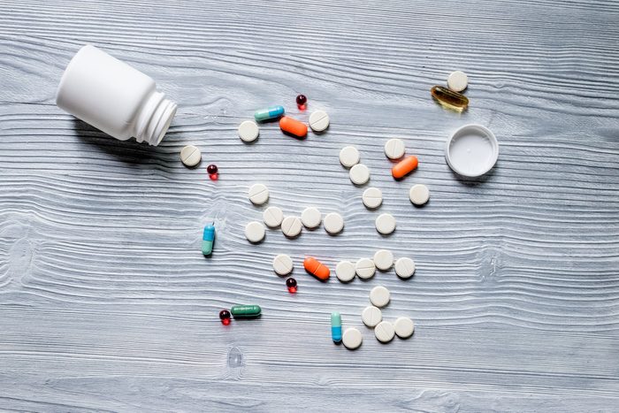 bottle with different pills spilling out