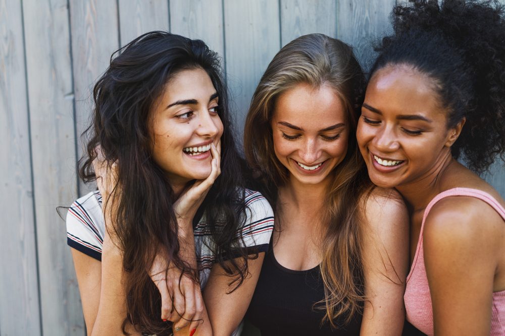 three young women having fun outdoors