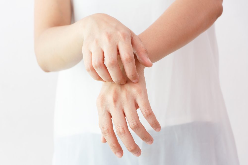 Women scratch the itch with hand / arm itching / Concept with Healthcare And Medicine.