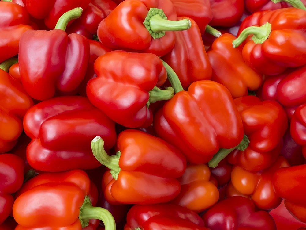 A lot of red bell peppers. Vegetables background. Top view.