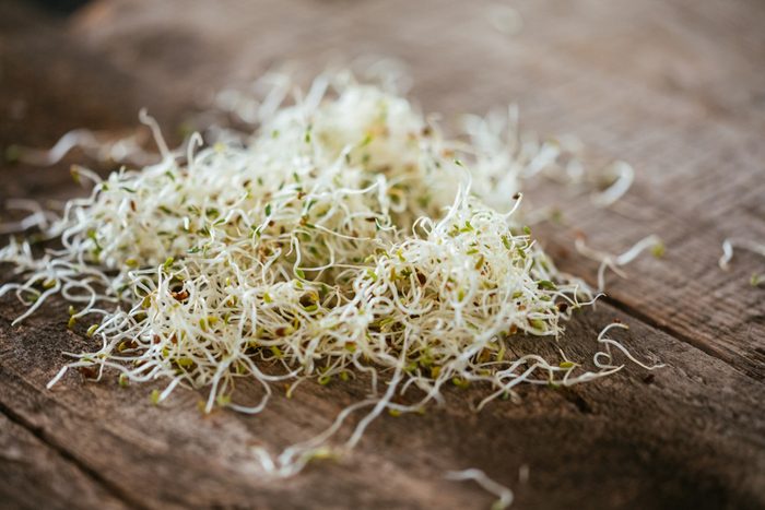 Fresh Alfalfa Sprouts On A Wooded Table