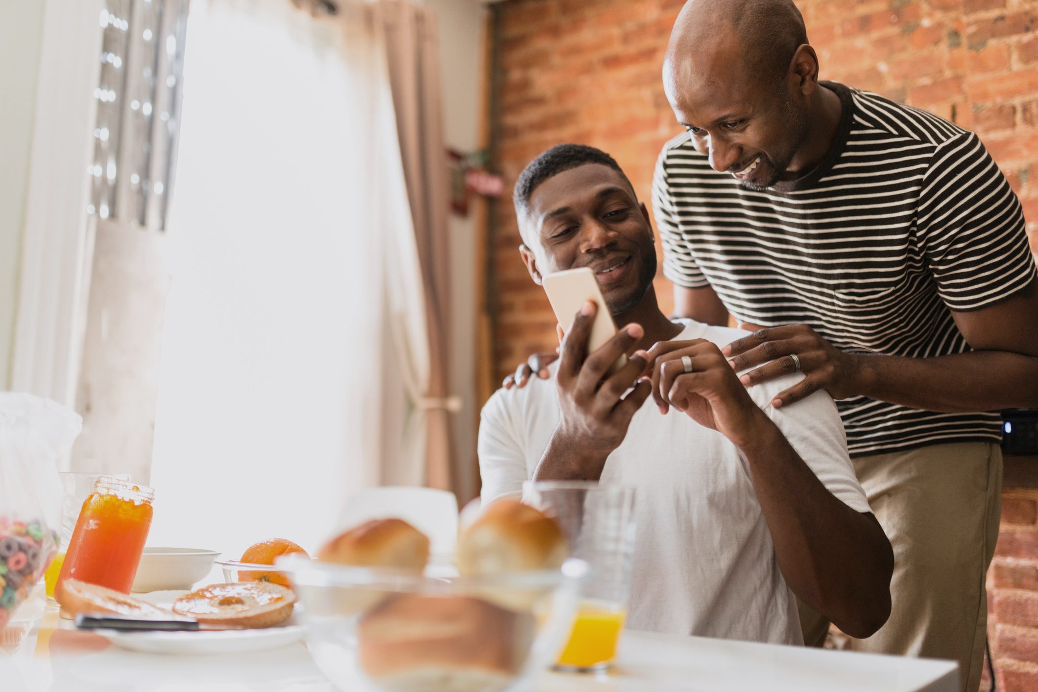 couple laughing during breakfast at home in the morning