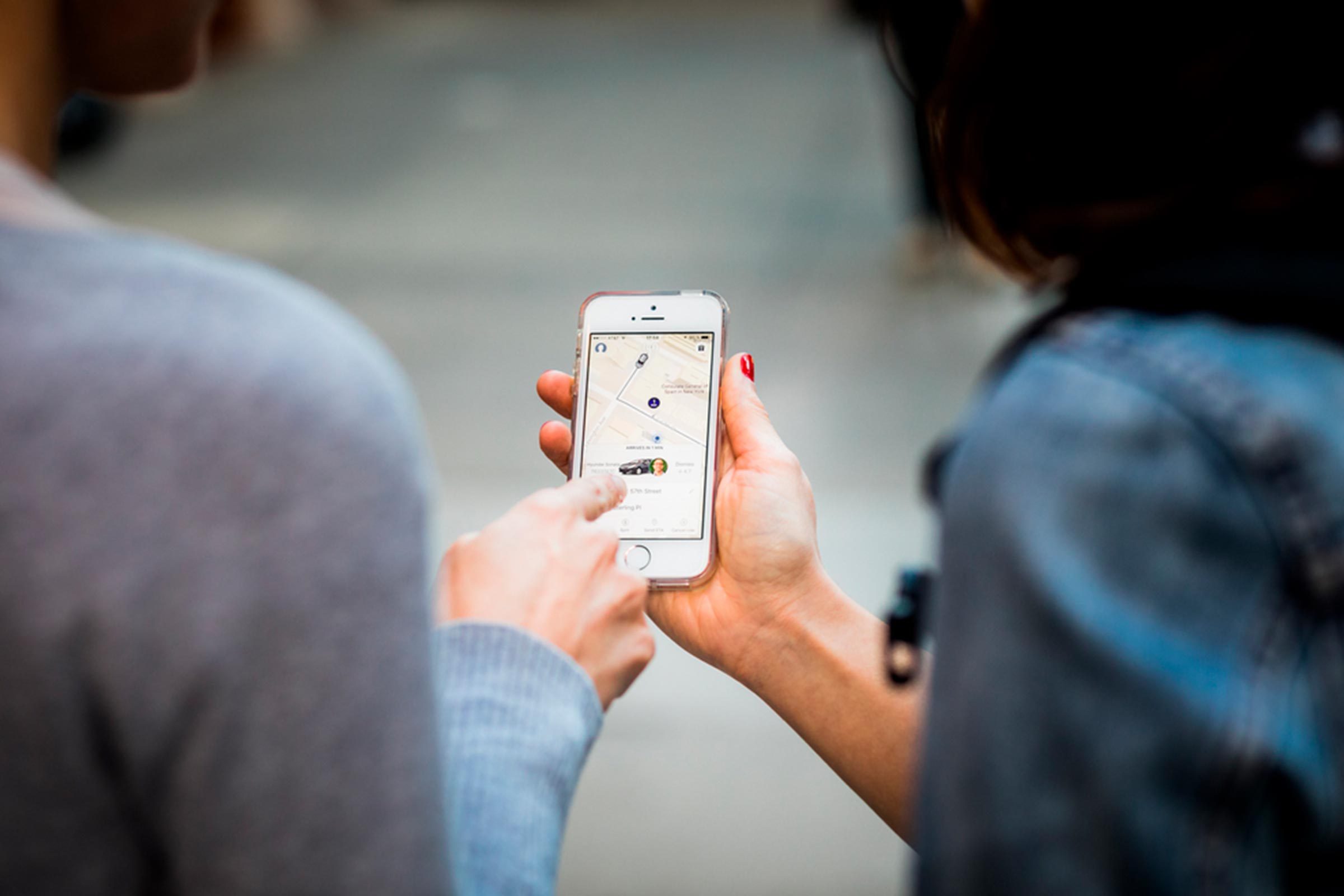 man and woman looking at phone