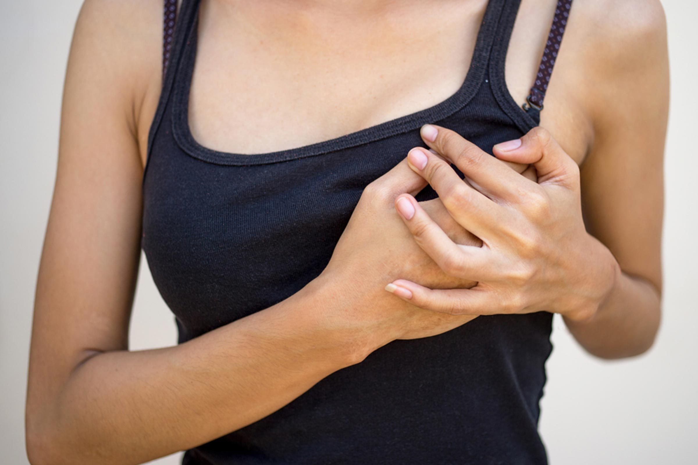 woman with hand on her breast