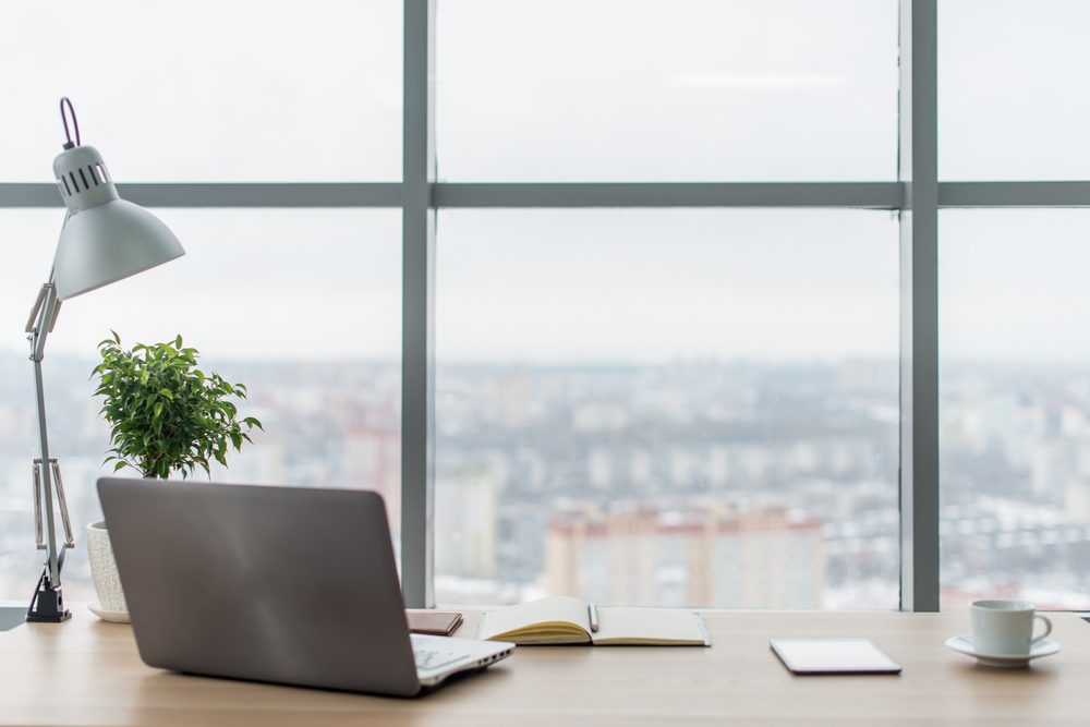 corner office with laptop and view