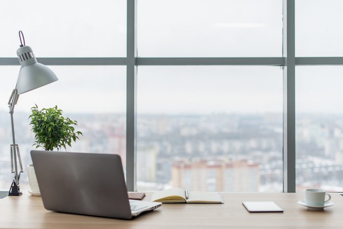 corner office with laptop and view